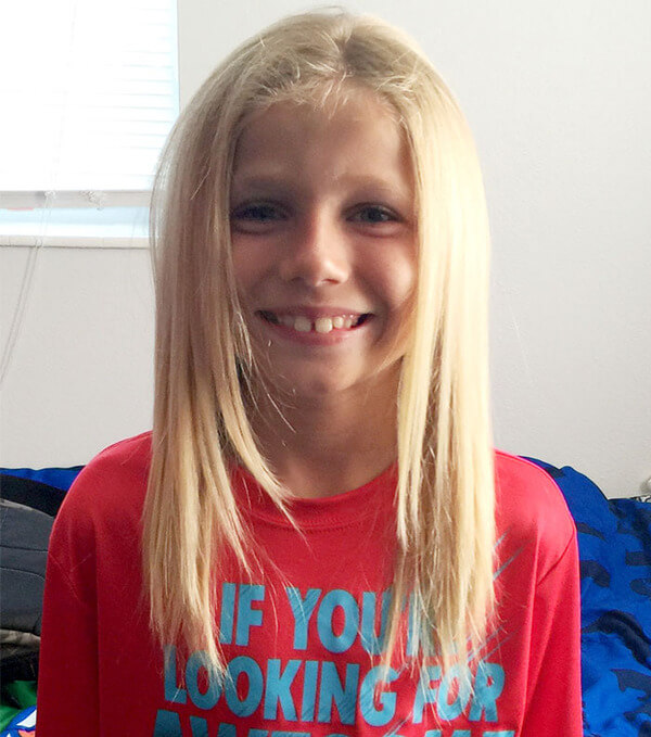 boy cuts long hair for cancer wigs 1