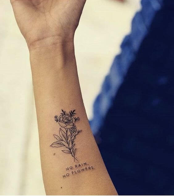no rain no flowers arm tattoo