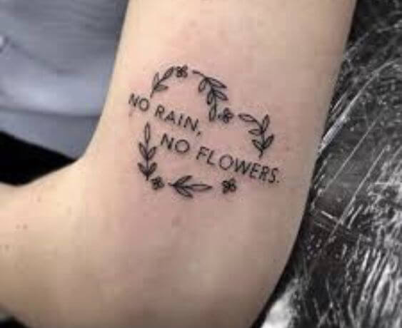 heart shaped tattoo of rain and flowers