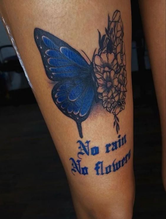 big blue tattoo of butterfly with no rain no flowers tattoo