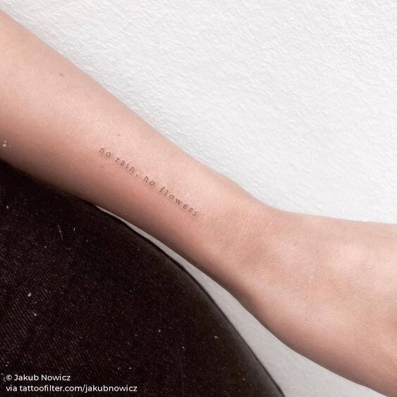 very thin tattoo on the arm