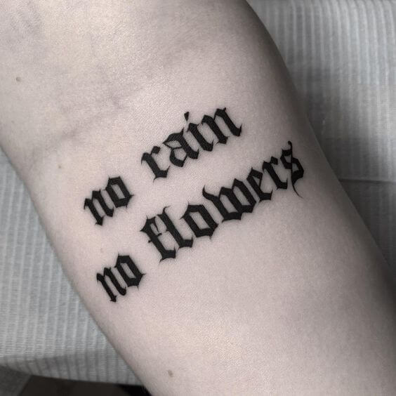 bold text with goth font text tattoo